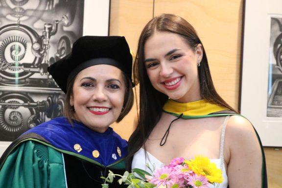 Two women smiling, graduation day